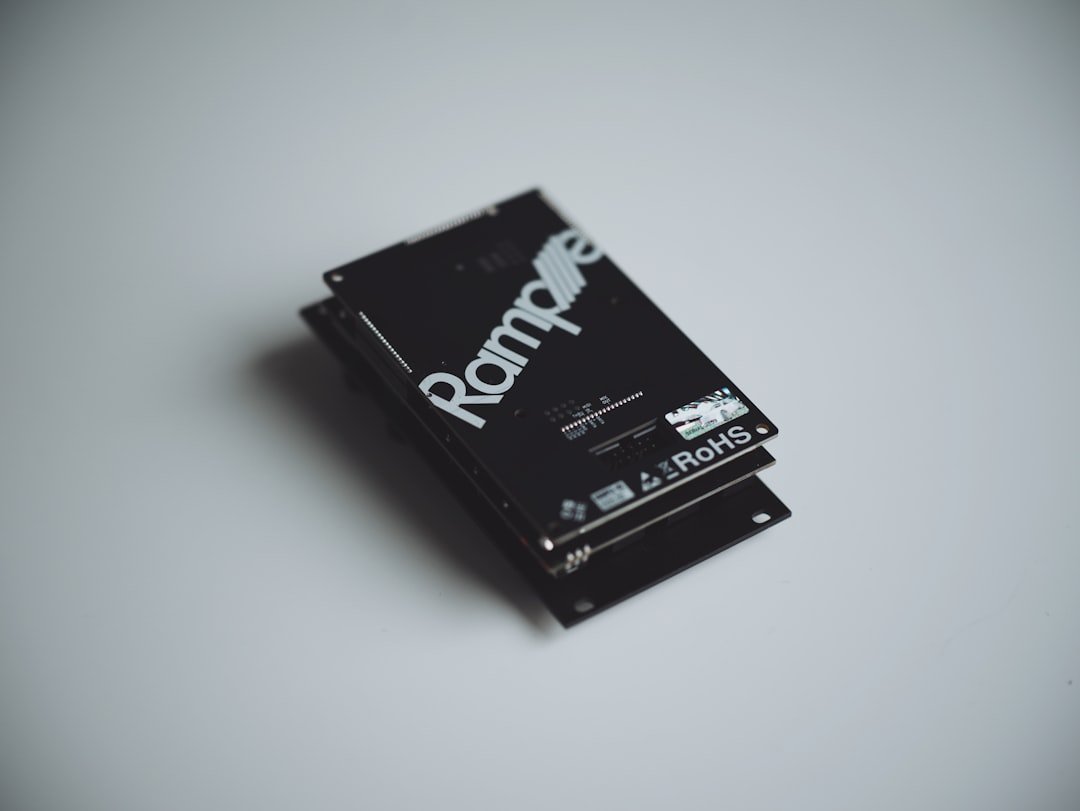 Stack of black electronic components on white surface